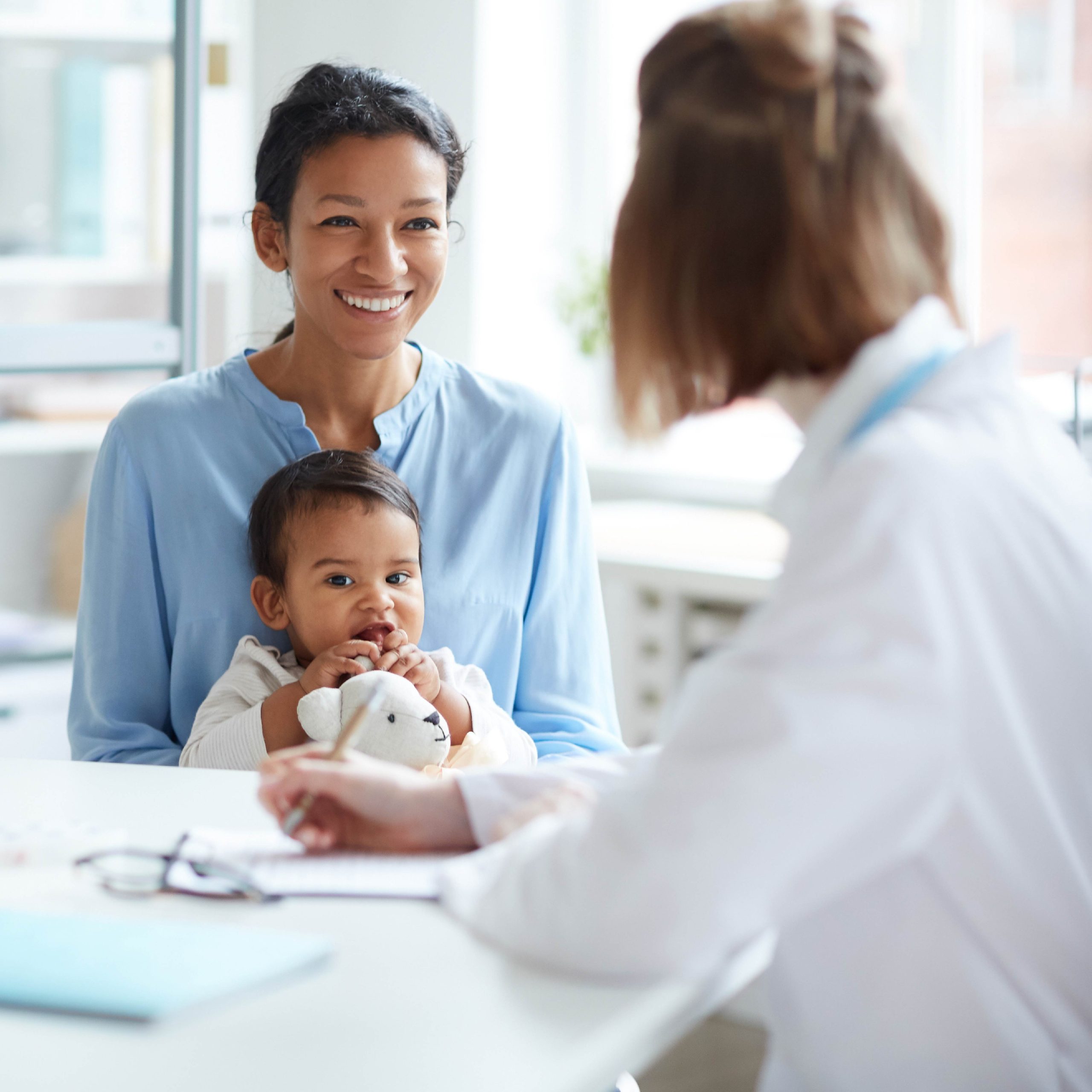 doctor looking at mom and baby